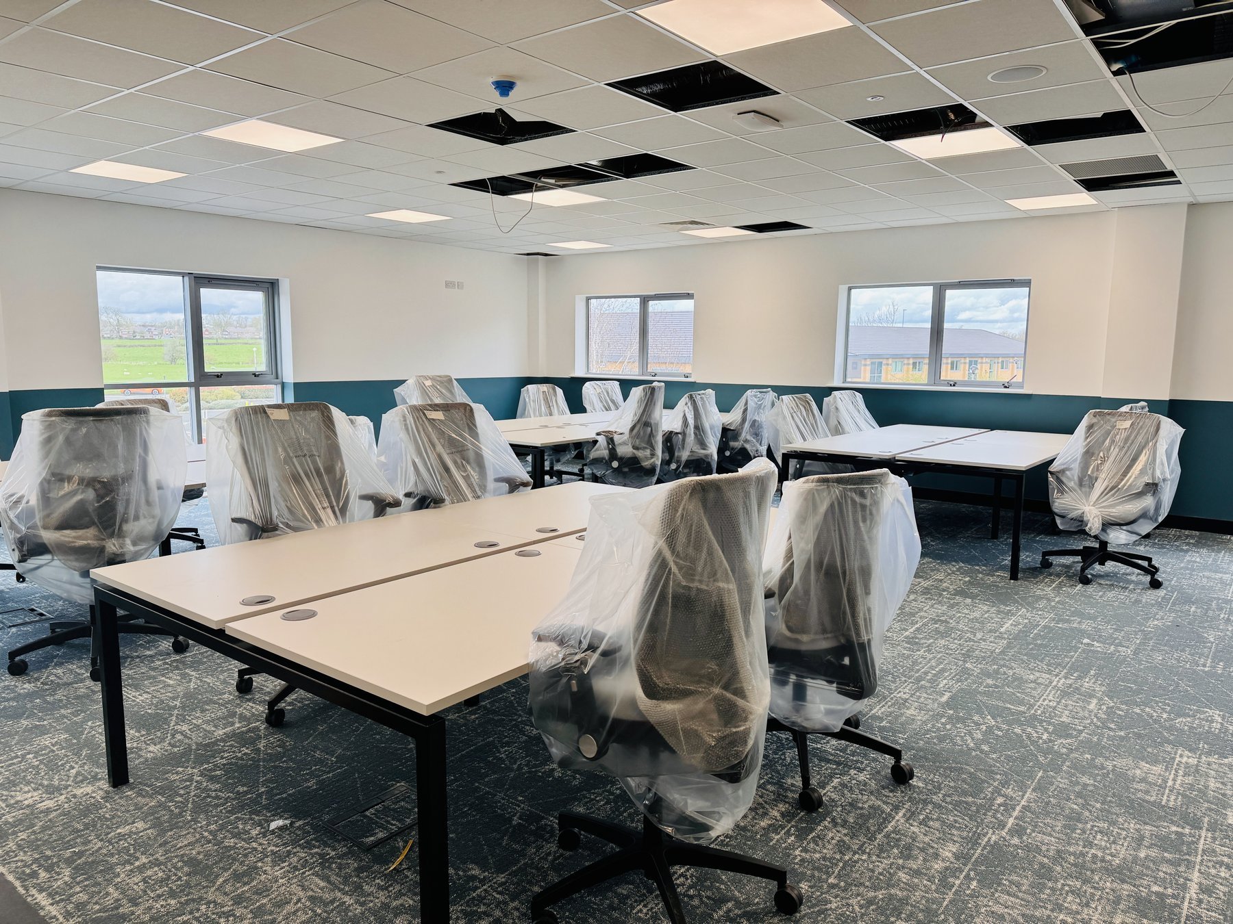 Bench desking installed and task chairs still wrapped on site during a Switch furniture installation
