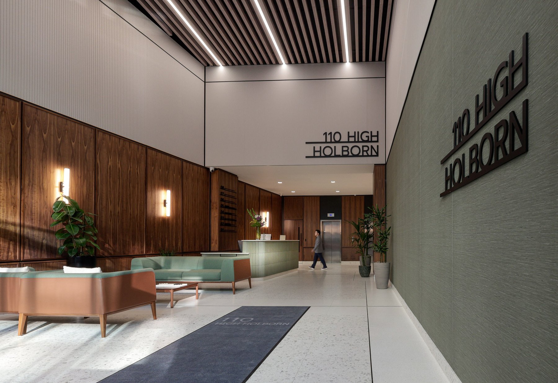 110 High Holborn reception with contract-grade lounge seating, walnut panelling and a fluted reception desk